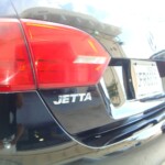 Before and after photographs of a damaged black Volkswagon Jetta that was repaired by Elite Paint & Body Shop in West Palm Beach, Florida.